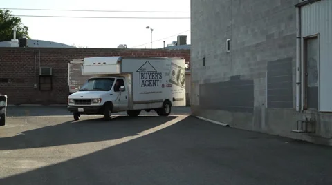 Moving truck turns corner in empty parking lot Stock Footage 56779691