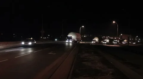 Moving Trucks or lorries with oversized cargoes and flashers at night Stock Footage 49669909