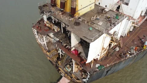 Moving upward along the opened stern of a ship at a ship breaking yard Video stock 327167470