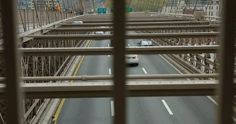 Moving Upwards In Slow Motion of Busy Traffic Travelling Under Brooklyn Bridge  Stock Footage 112332840