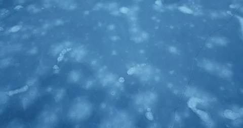 Moving very close over the deep blue surface of a frozen lake Stock Footage 122403661