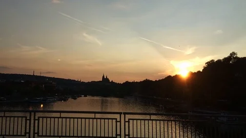 Moving view from a bridge with Prague castle and sunset in the background Stock Footage 107282797