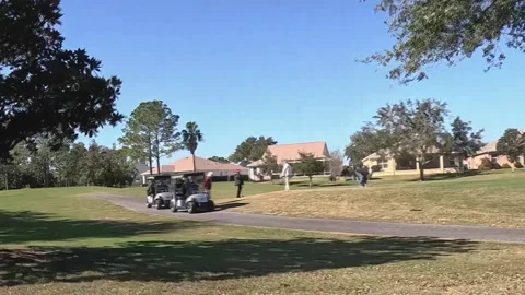 Moving view of golf course with golfers at The Villages Florida Vídeo Stock 331431926