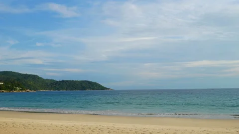 Moving water wave hit sand shore coast, nobody on beach, mountain cape long d Stock Footage 130565005