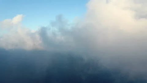 Moving white clouds blue sky on coastline and sea surface scenic aerial view Stock Footage 136437425