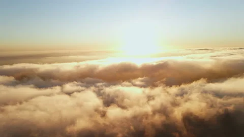 Moving white clouds blue sky scenic aerial view sunset. Sun is hidden at fog Stock Footage 142953752