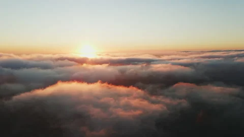Moving white clouds blue sky scenic aerial view sunset. Sun is hidden at fog Stock Footage 142954752