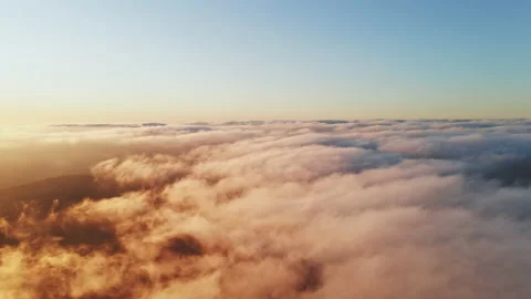 Moving white clouds blue sky scenic aerial view sunset. Sun is hidden at fog Stock Footage 142955025