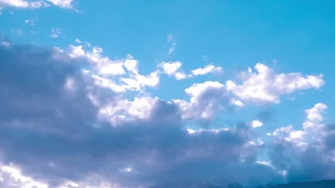 Moving white clouds on the blue sky in time laps Stock Footage 167723894