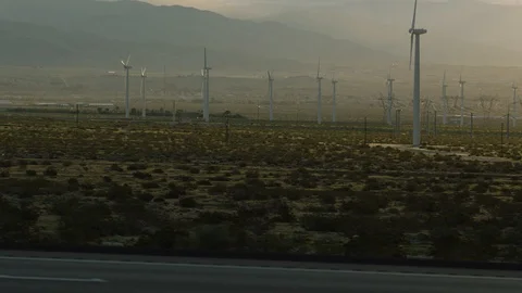 Moving by a windmill plant at sunset Stock Footage 106474051