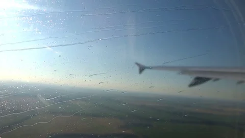 Moving window of an airplane during a rain in flight Stock Footage 95567051