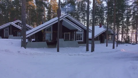 Moving at winter by cozy wooden house in snowy forest village. Stock Footage