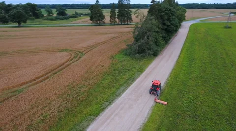 Mowering the thick green grasses on the field Видео 67280731