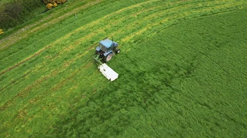 Mowing field with tractor, side shot, stopping Stock Footage 238826932