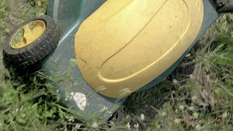 Mowing grass in the garden with electrical machine Stock Footage 91177282