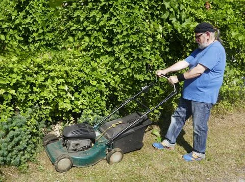 Mowing the grass in the sun Foto stock