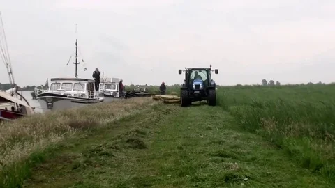 Mowing the lawn with tractor in the fields Stock Footage 82068832