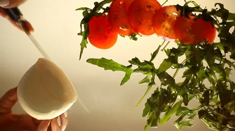 Mozzarella, arugula and tomatoes - sliced for salad. hands closeup Stock Footage 63087657
