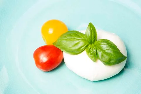 Mozzarella, basil and cherry tomato Фото