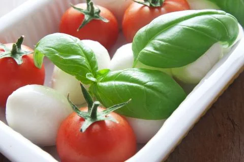 Mozzarella, basil and tomatoes Stock Photos