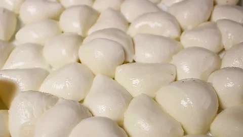 Mozzarella cheese balls rotating pattern macro texture background backdrop Stock Footage 91377613