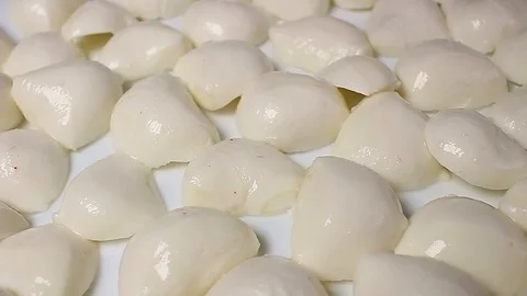 Mozzarella cheese balls rotating pattern macro texture background backdrop Stock Footage 91379878