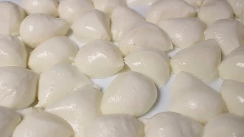 Mozzarella cheese balls rotating pattern macro texture background backdrop Stock Footage 91379896