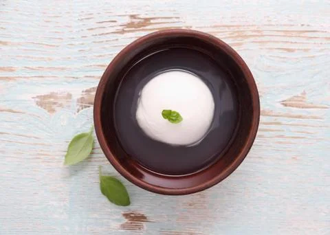 Mozzarella cheese in brine, basil leaf Foto stock