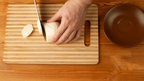 Mozzarella - cheese is cut with a knife on the same parts. Stock Footage 108275399