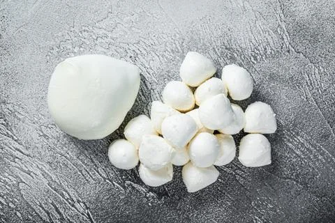 Mozzarella cheese mini balls on kitchen table. White background. Top view Stock Photos