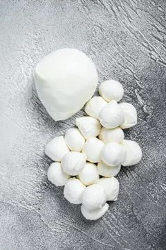 Mozzarella cheese mini balls on kitchen table. White background. Top view Stock Photos