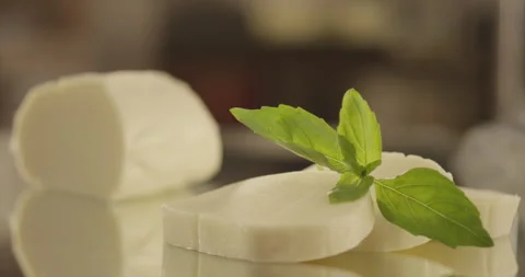 Mozzarella cheese slices with falling basil Stock Footage 200257029