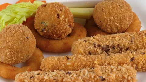 Mozzarella cheese sticks, cheese balls and onion rings, deep fried snacks Stock Footage 78528310