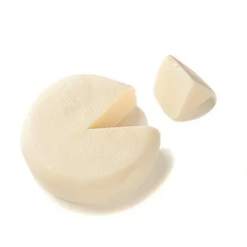 Mozzarella cheese without packaging. A piece of triangular shape has been cut 스톡 사진