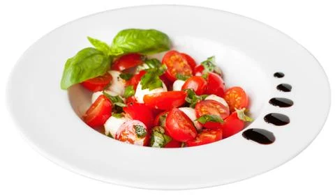 Mozzarella, cherry tomatoes and basil salad Stock Photos