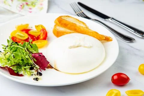 Mozzarella with spinach, cherry tomatoes, wild berries and bread side view Stock Photos