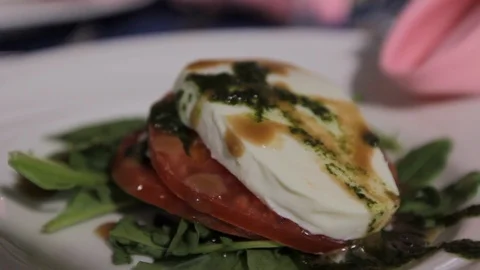 Mozzarella tomato and spinach leaves on plate Stock Footage 92000266