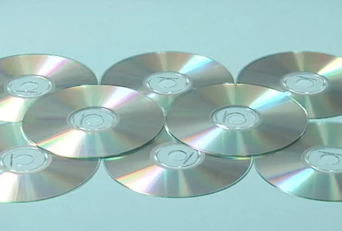 MP3 player lands on cds - slow motion Stock Footage 704807
