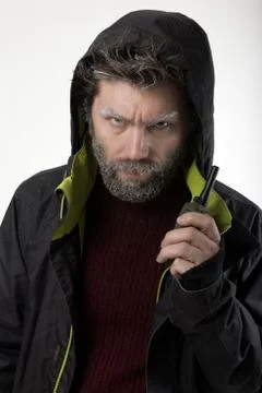 Mr. IceMan aggression, he talking on walkie-talkie. fashion man in knitted Stock-Fotos