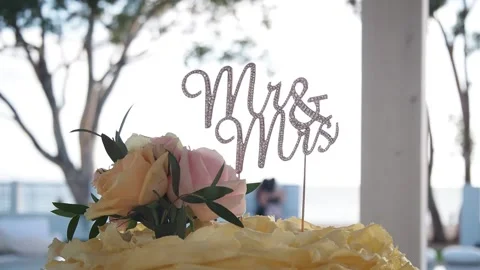 Mr &amp; Mrs Wedding Cake Topper On A Beautiful Background Stock Footage 157650028