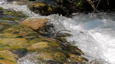 MREZ 22 Clean fresh sparkling water flowing over green rocks 1 Stock-Footage 39738370
