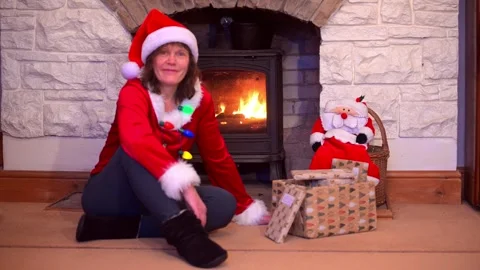Mrs Santa by the fireplace. Stock Footage 325391107