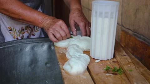 Mrs Sofia cuts Halloumi chesse in Sofia Traditional House, Letymbou, Cyprus Stock Footage 232927992