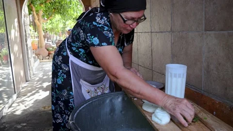 Mrs Sofia making Halloumi chesse in Sofia Traditional House in Letymbou, Cyprus Stock-Footage 232927753