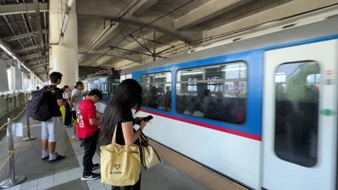 MRT train arriving at Guadalupe station with commuters in Manila 4k Stock Footage 337439869