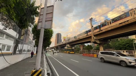 MRT Train EDSA Carousel Bus Moving Together Ortigas Golden Hour Wide 4K 60fps Stock Footage 338186649