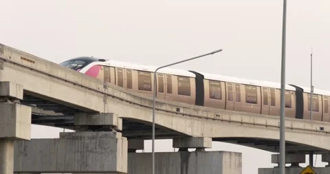 An MRT train passes on one of its tracks in Bangkok, Thailand Stock Footage 303146549