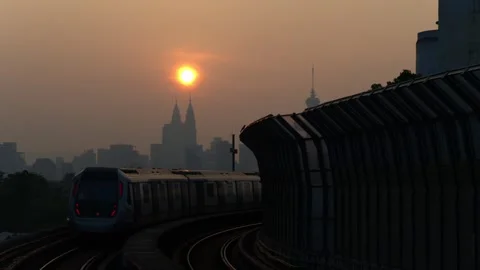 MRT Train passing through station, KLCC Twin towers and KL Tower in the Stock Footage 345641091