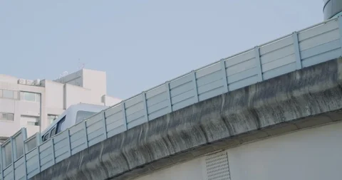 MRT train runs through elevated railway in front of buildings Stock Footage 101958493