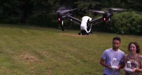 MS Aerial drone piloted by man and woman Stock Footage 80305809